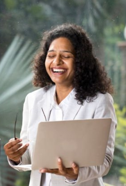 Happy employee holding laptop and specs